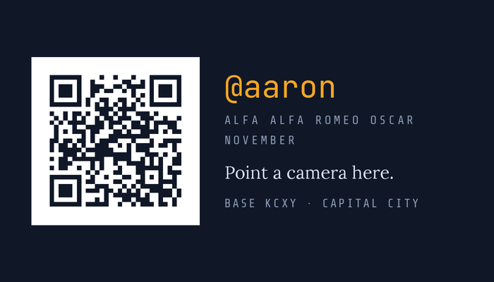 The back: a QR code, @aaron, and the callsign spelled out